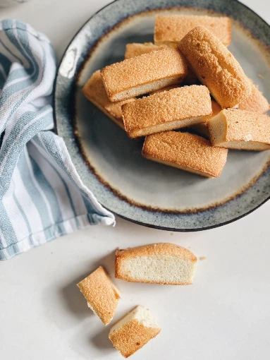 Handful of financiers in a plate seen from above